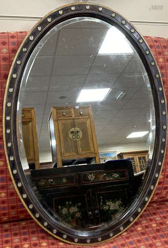 A 19th century oval Irish wall mirror with painted simulated...