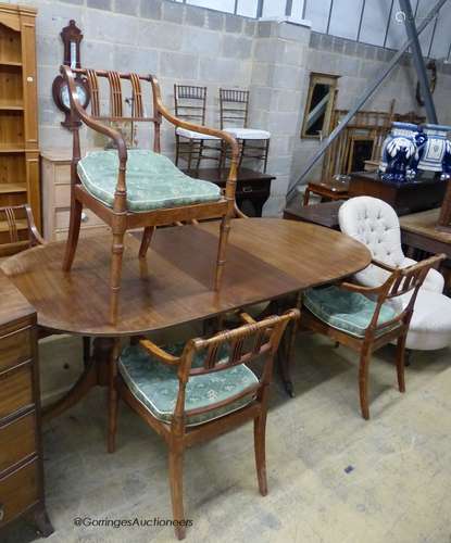 A reproduction mahogany twin pillar extending dining table a...