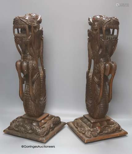 A pair of Burmese carved hardwood 'dragon' lamps, height 50c...