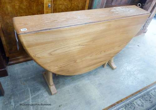 An Ercol drop leaf dining table, 180cm extended, width 128cm...