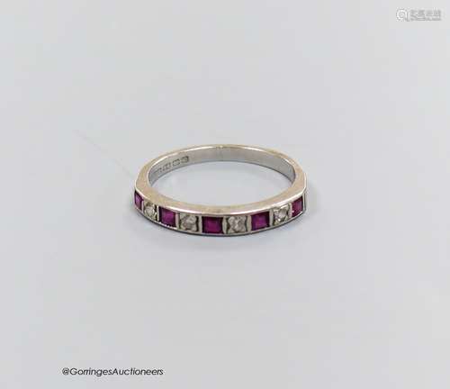 And 18 carat white gold ruby and diamond half eternity ring,...