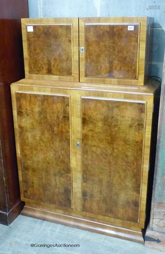 An Art Deco burr walnut veneered cocktail cabinet, length 94...