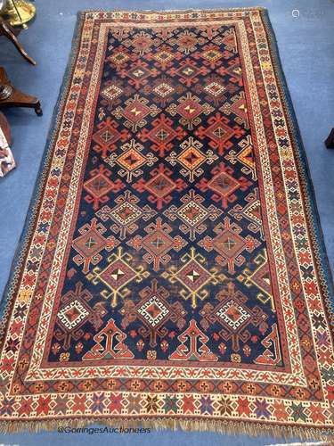 A Caucasian blue ground rug, woven with hooked lozenges, 288...