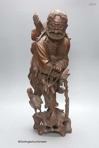 An early 20th century Chinese hardwood carving of a luohan f...