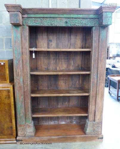 An Indian carved painted hardwood open bookcase, length 146c...