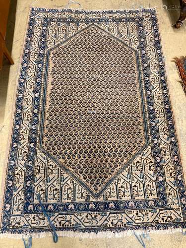 A North West Persian ivory ground rug, 188 x 120cm together ...