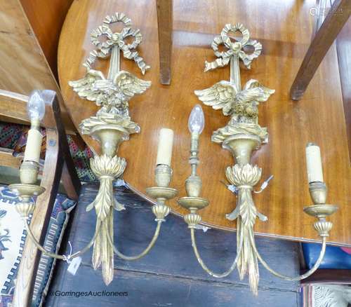 A pair of carved giltwood and gesso linenfold eagle two bran...