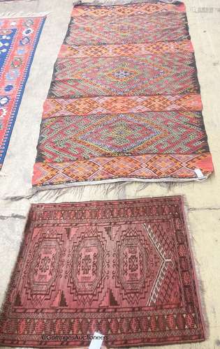 A polychrome flatweave geometric rug, 240 x 124cm together w...