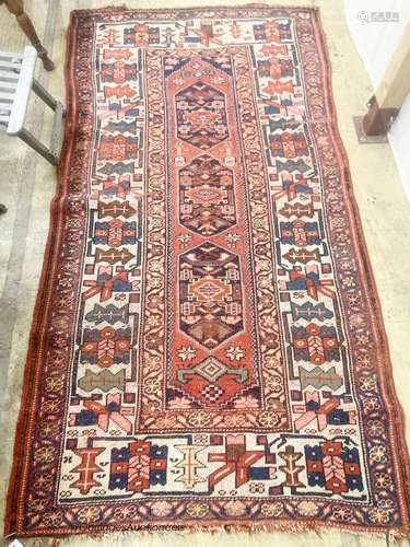 A Caucasian red ground rug, 218 x 112cm