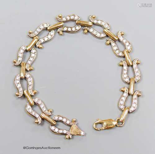 A 9ct gold and paste bracelet, with stylised horseshoe links...