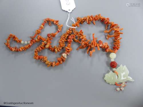 A jagged coral bead necklace, with jade pendant, carved as a...