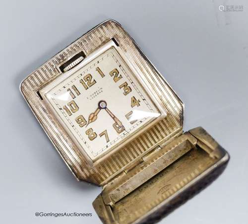 A silver Gubelin travelling watch with snakeskin outer case,...