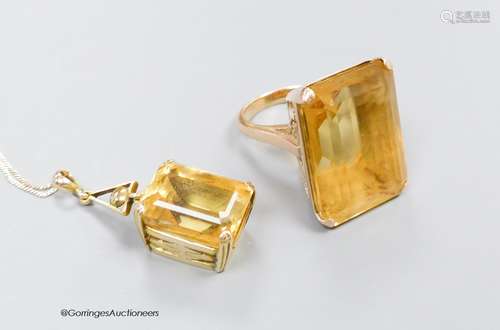 A large yellow metal mounted citrine ring, size M, gross 19....