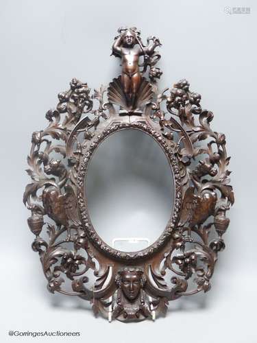 A 19th century Italian carved walnut oval picture frame, 41 ...