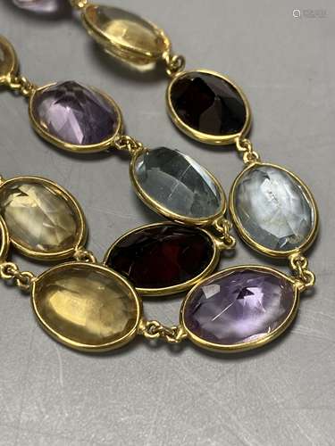 An 18ct gold multi gem spectacle set necklace, 48cm.