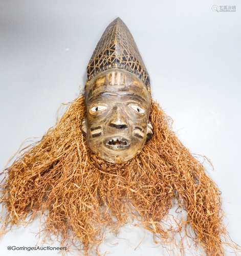 A Bapende tribal carved wood mask, 41cm high