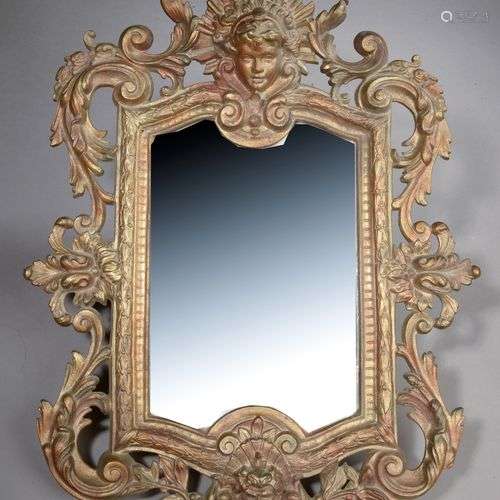 Miroir en bronze doré à décor de rinceaux feuillagés et masc...