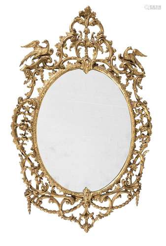 A CARVED GILTWOOD OVAL WALL MIRROR, IN GEORGE III STYLE, SEC...