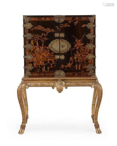 A BLACK LACQUER AND GILT CHINOISERIE DECORATED CABINET ON GI...