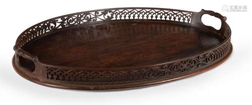 A GEORGE III MAHOGANY OVAL TRAY, IN THE MANNER OF THOMAS CHI...