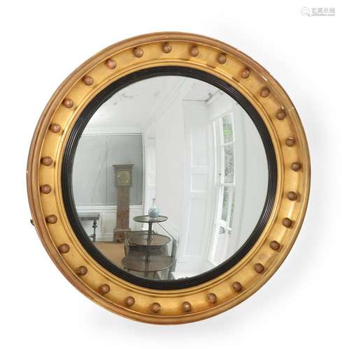 A REGENCY GILTWOOD CIRCULAR CONVEX WALL MIRROR, CIRCA 1815