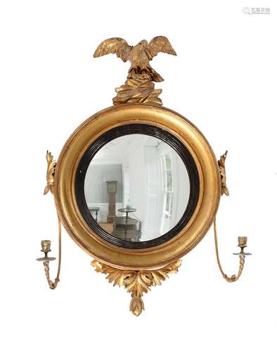 A REGENCY CARVED GILTWOOD CONVEX WALL MIRROR, CIRCA 1815