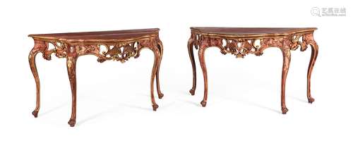 A PAIR OF CONTINENTAL RED PAINTED AND PARCEL GILT CONSOLE TA...