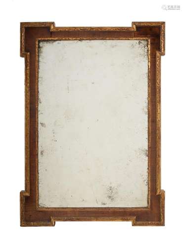 A GEORGE II WALNUT AND PARCEL GILT WALL MIRROR, IN THE MANNE...