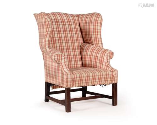 A MAHOGANY AND UPHOLSTERED WING ARMCHAIRIN GEORGE III STYLE