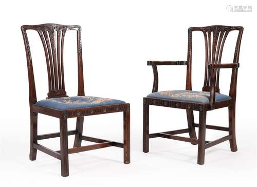 A SET OF TWELVE CARVED MAHOGANY DINING CHAIRS, IN GEORGE III...