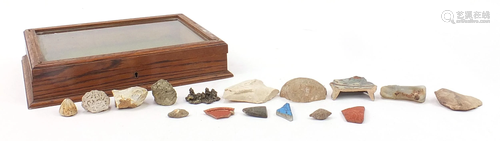 Antiquities arranged in a glazed oak display case