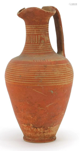 Geometric trefoil lipped pottery jug with red painted