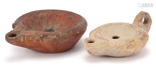 Two Roman terracotta oil lamps, one with handle, the