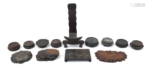 Thirteen Chinese carved hardwood stands to including a