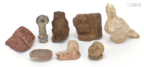 Stone antiquities including a marble carving of a bird