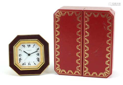 Cartier red and gold coloured desk strut clock, the