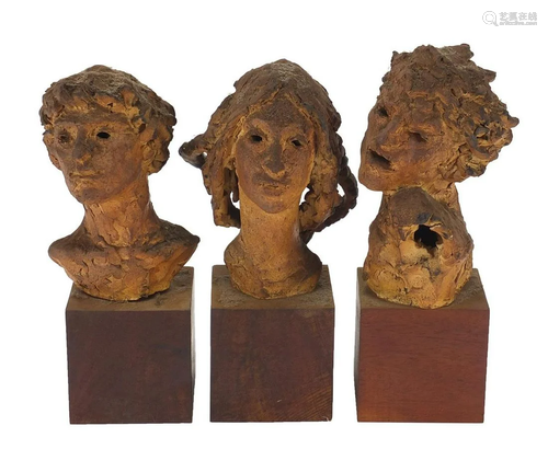 Three mid century pottery busts raised on wooden block