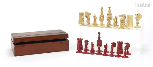 Half stained carved bone chess set and a mahogany case,