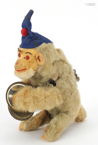 Vintage wind up monkey playing the cymbals, the monkey