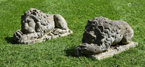 A PAIR OF COMPOSITION STONE MODELS OF RECUMBENT LIONS, 20TH ...