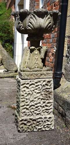 A COMPOSITION STONE 'LEAF VASE' ON A RUSTICATED PEDESTAL, SE...