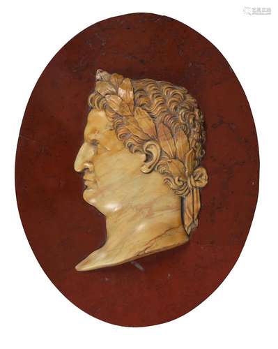 AN ITALIAN GIALLO ANTICO OVAL RELIEF PORTRAIT OF THE ROMAN E...