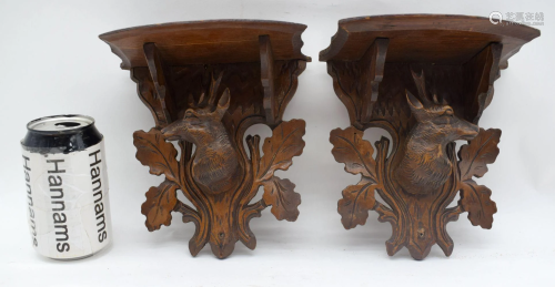 A pair of carved black forest wall scones 18cm (2).