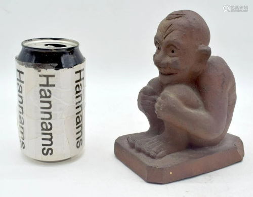 A small terracotta crouching man 15cm.