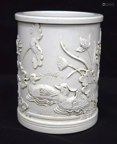 A Chinese porcelain brush pot decorated in relief with