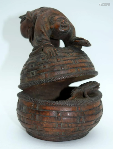 An unusual Chinese carved hardwood figure of a male on