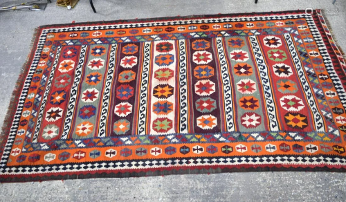 A large Persian Kashcai rug. 304 x 167cm