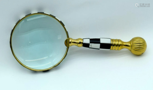 A desk top magnifying glass with stone chequered handle