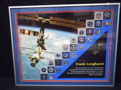 A framed NASA set of enamelled badges presented Frank