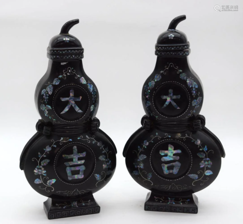 A pair of two small Chinese wooden painted lidded vases